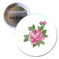 Embroidered rose pinback button brooch with pink flower and green leaves, circular metal backing