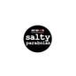 Black round pinback button with white 'salty parabolas' text