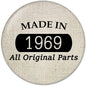 1969 pinback button with fabric-textured face, black banner reading 1969, Made in 1969