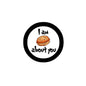 2.25-inch pinback button with black rim, 'I am about you' and orange nut icon