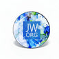 Round pinback button with blue floral design and JW.org logo, silver edge.