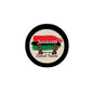 Juneteenth button pin with black rim; beige center, red banner, green elements, 'Celebrate Freedom'