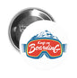 Cartoon goggles pinback button with Keep on Boarding text and mountain graphic
