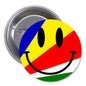 Round pinback button with smiley face in blue, yellow, red and green flag colors