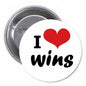 Round pinback button with white face, red hearts, and “I ♥ wins” text