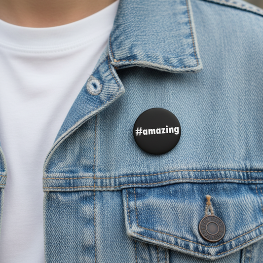 Round black pinback button with white “#amazing” text