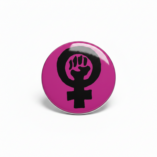 Pink button with black female symbol and raised fist on a white background