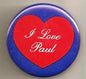 Round blue pinback button with red heart and white "I Love Paul" lettering.