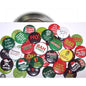 Assorted round holiday pinback buttons with colorful sayings, green red and gold