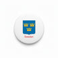 Round pinback badge with Sweden text and blue coat-of-arms shield, black rim