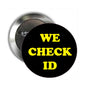 Black pinback badge reading "WE CHECK ID" with safety clasp