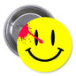 Round yellow smiley pinback button with black eyes and curved smile