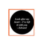Black round pinback badge with white script quote text inside