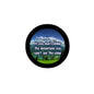 Round pinback badge with black rim, landscape graphic, and quote text