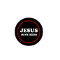 Round badge pin with black face, red ring border, and white “JESUS IS MY HERO” text