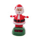 Solar-powered dancing Santa figurine in red suit with white beard on green base