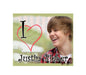 Square mouse pad with cartoon-style photo of Justin Bieber and red heart graphic