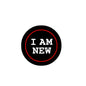 Black round pinback badge with red ring and "I AM NEW" lettering