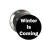 Pinback button with black front and white 'Winter is Coming' text; silver metal backing.
