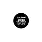 Round black pinback button with 'AARON SMITH CHANGED MY LIFE' text