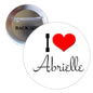 Round pinback button with red heart and "I heart Abrielle" text