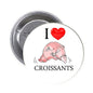 1.25-inch round pinback button with I heart croissants text and croissant illustration
