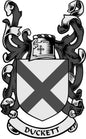 Family crest pinback with shield chevron, ornate wings, and “DUCKETT” ribbon