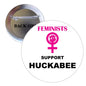 2.25-inch pinback button, circular, pink symbol and text 'Feminists support Huckabee'