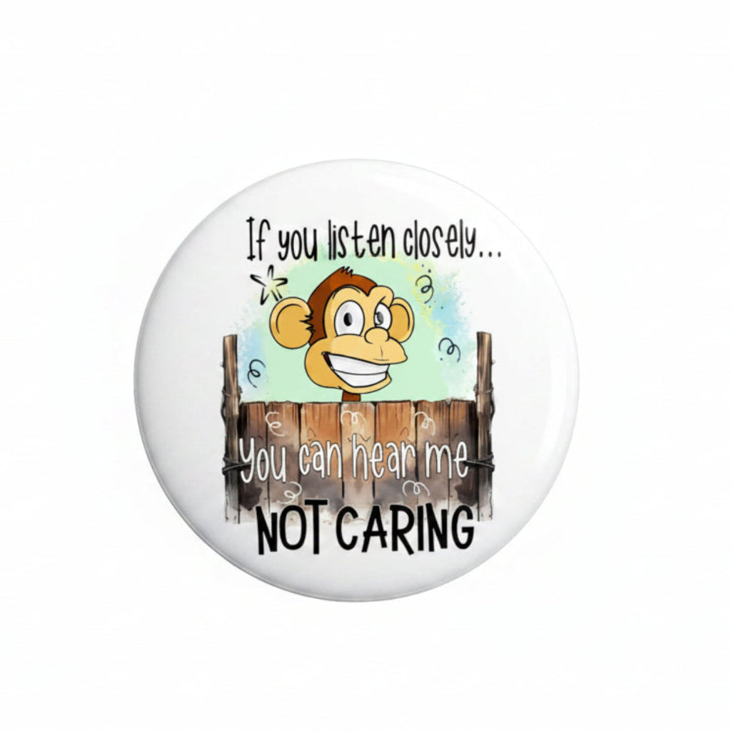 Round cartoon monkey funny button badge with text "NOT CARING" and "hear me"