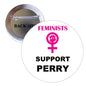 Round pinback button: pink female symbol, “Feminists Support Perry” text
