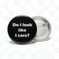 1.25-inch black pinback button with 'Do I look like I care?'
