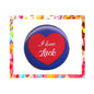 Round pinback button with blue rim, red heart, "I love Luck" text