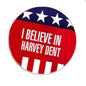 Round pinback badge with 'I BELIEVE IN HARVEY DENT' and star banner, red/blue