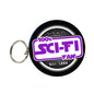 Sci-Fi fan keychain: round black badge with purple '100% Sci-Fi Fan' text