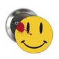 Yellow smiley face pinback badge with black features and red splatter on face