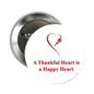 Round pinback brooch with red heart and 'Thankful Heart' quote
