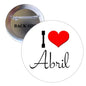 Abril pinback button with red heart, 'Abril' script, and metal pin back visible