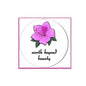2.25-inch pinback badge with purple flower and 'worth beyond beauty' text