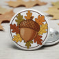 2.25-inch acorn woodland pinback with autumn leaves, round button badge