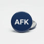 AFK pinback button, 2.25-inch, round navy front with AFK logo; silver clasp back visible