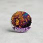 Afro crazy pinback button with colorful curly hair portrait and 'Roots' text, round