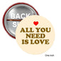 All You Need Is Love heart pinback badge, round 1.25-inch, cream background
