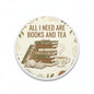 2.25-inch round pinback button: books and tea graphic, cream with 'All I Need Are'.