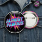 2.25-inch pinback button with round metal border, color 'ALMOST FAMOUS' comic graphic