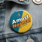 2.25-inch pinback button in teal/yellow with 'Almost Normal' text and smile