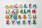 Set of cartoon-style alphabet letter magnets with colorful uppercase letters A–Z