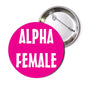 Circular pinback button with magenta face and white 'ALPHA FEMALE' text; silver back pin.