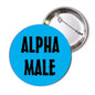 Round pinback button with blue face and black “ALPHA MALE” text, silver safety-pin back