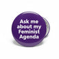 Purple pinback button with text "Ask me about my Feminist Agenda".