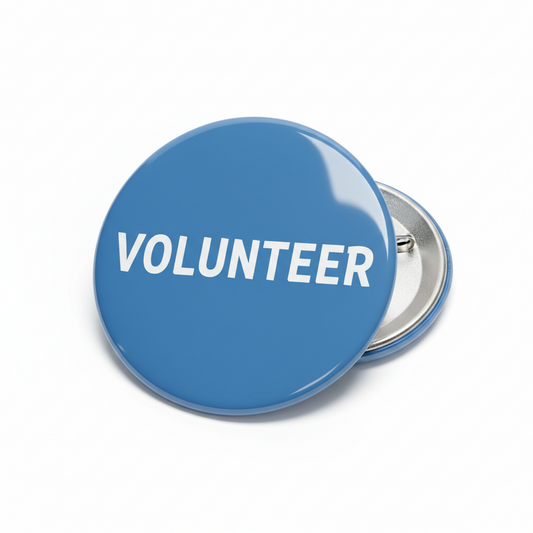 Blue volunteer pinback button with white "VOLUNTEER" text and metal pin